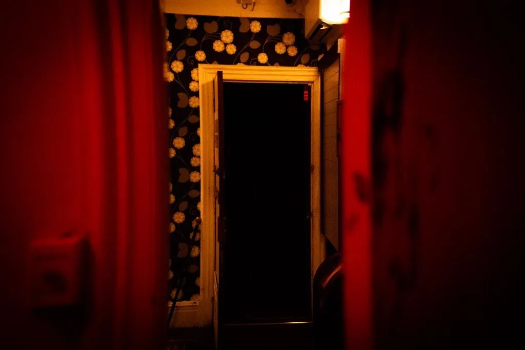 A red-curtained corridor leading into the Cannibal set