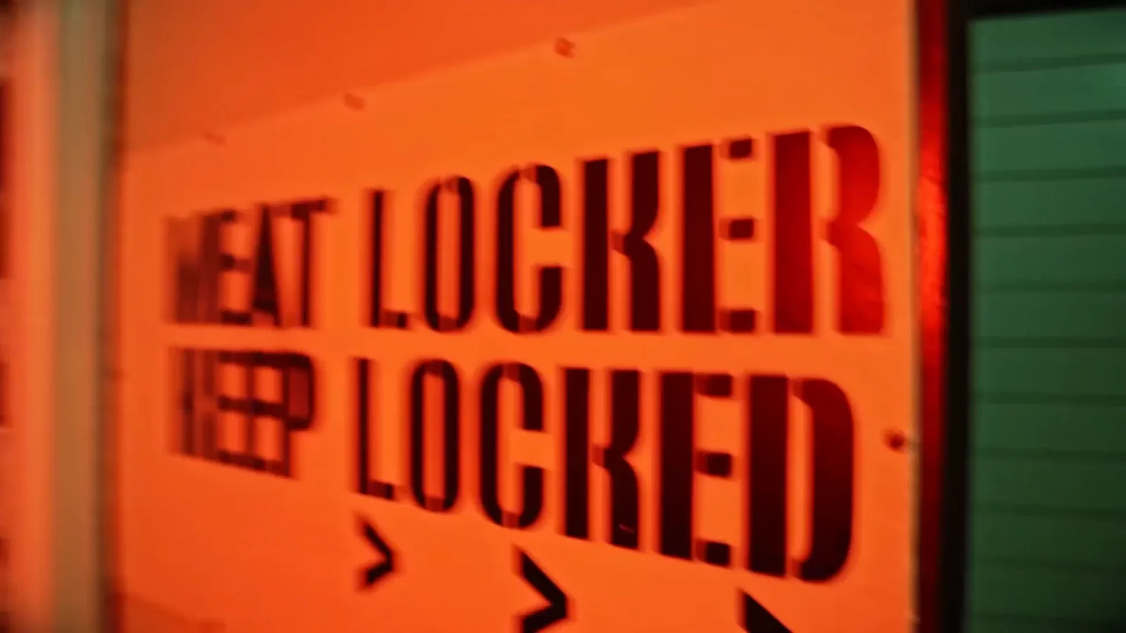 A stencilled ‘Meat locker, keep locked’ sign in the Cannibal escape room
